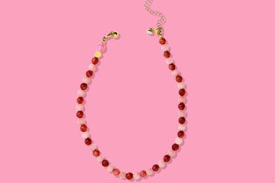 Beaded necklace on a pink background