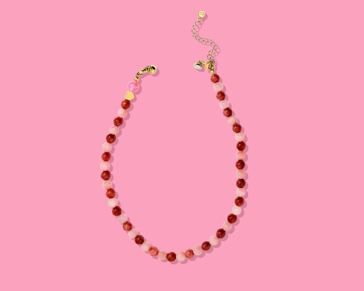 Beaded necklace on a pink background
